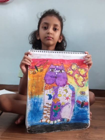 A wonderfully creative cat drawing by Harshita, a 3rd-grade student. She used oil pastels on paper to create a vibrant and imaginative character with unique patterns and colors.