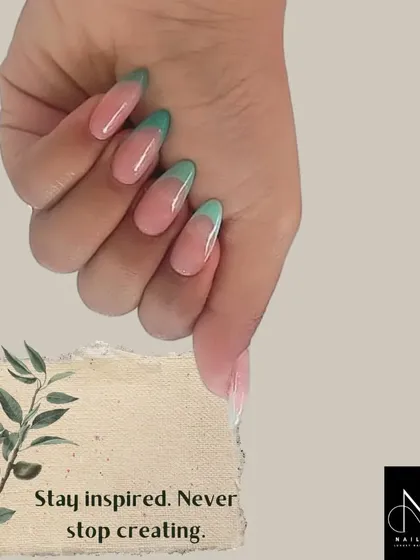 A soft and subtle colored French manicure. We used a lovely mint green for the tips on these almond-shaped nails for a fresh and understated look.