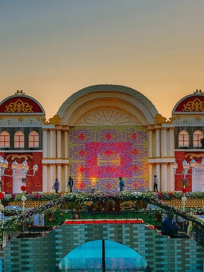 A spectacular, custom-built stage designed to look like a European town square at sunset. This shows our ability to create large-scale, highly thematic, and imaginative wedding decor.