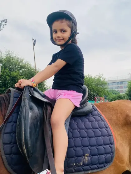 This young rider looks comfortable and happy on her horse, a testament to our gentle approach to teaching kids.