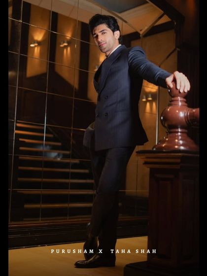 A vision in tailored finesse. Taha Shah redefines modern royalty in this impeccably cut navy suit, a testament to classic style.