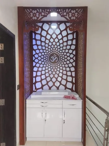 A modern pooja unit I designed to fit into a compact space. The backlit CNC-cut panel with the 'Om' symbol creates a serene focal point, and the white drawers below provide storage for prayer essentials.
