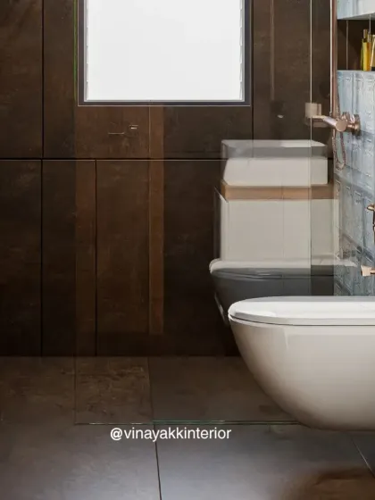 A close-up view of the wall-mounted toilet and the seamless integration of the shower's glass partition. These details contribute to a clean, minimalist aesthetic that is both modern and functional.