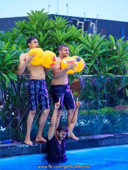Friends having fun and playing around in the pool.