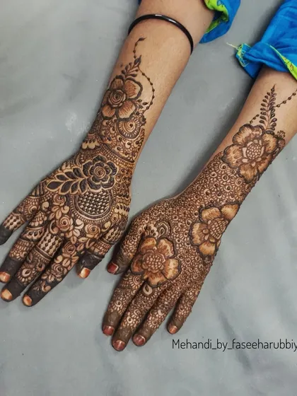 A view showing both hands, with one featuring a fresh paste application and the other a beautiful stain.