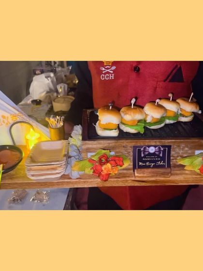 Our mini burger sliders are a modern classic with a gourmet twist. Served on a wooden platter by our professional staff, they are a favorite at parties.