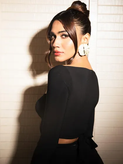 A stunning look for Apeksha Porwal. The combination of a sleek top knot, glowing skin, and a soft red lip is the definition of modern elegance.
