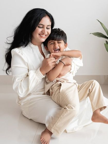 A mother and son sharing a big laugh together in the studio.