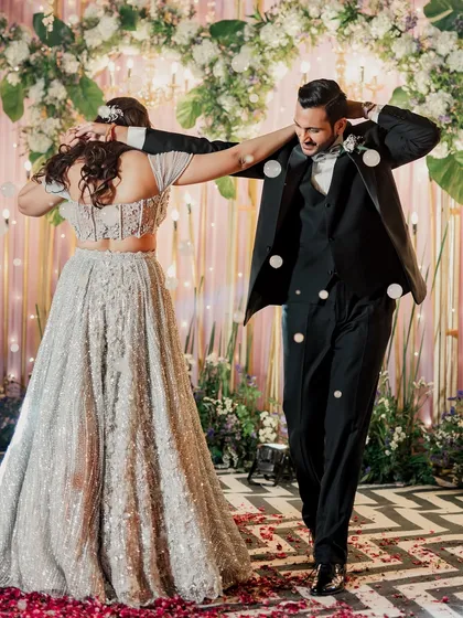 A fun and candid shot of the couple dancing, capturing their energy and the joy of the celebration.