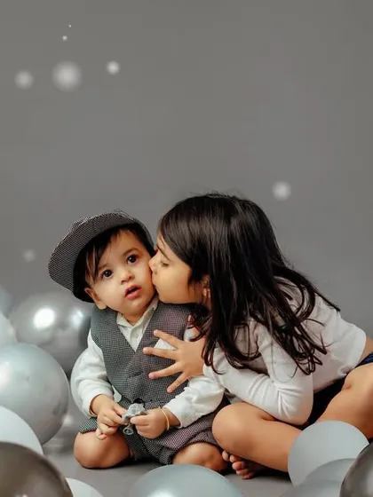 The bond between siblings is a story in itself. I love creating a relaxed space where their unique connection, from sweet kisses to playful moments, can shine through.