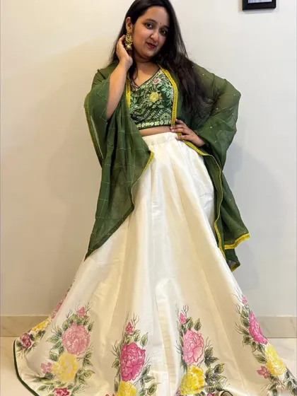 The full look, showing how the hand-painted skirt, embroidered blouse, and green dupatta create a unique and memorable outfit.
