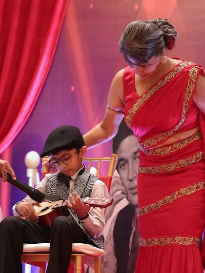 A young guest performing on the guitar, a sweet and personal moment during the celebration.