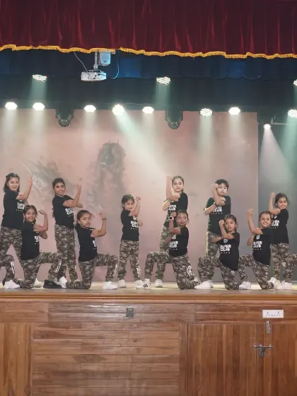 Our kids' hip hop crew in their cool camo outfits, striking a powerful pose. These classes teach the fundamentals of hip hop in a fun and age-appropriate way.