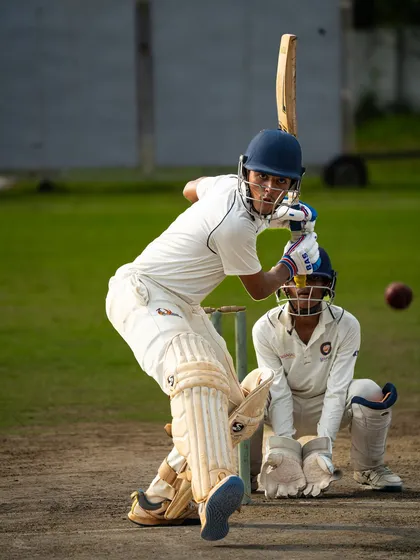 Eyes on the ball. A young batsman plays a confident shot, showcasing the technique and temperament we instill in our players from a young age.