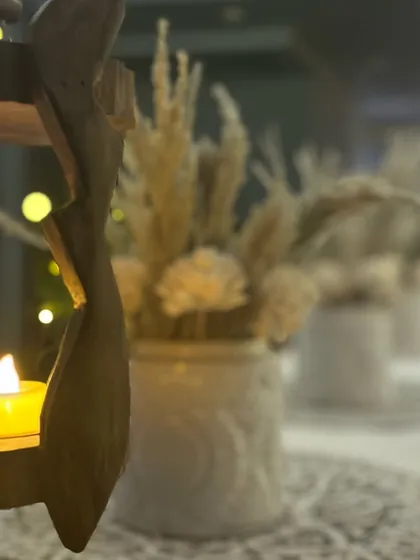 A close-up shot of a rustic wooden candle holder, with a soft-focus background of fairy lights. This highlights my focus on creating a warm, layered, and aesthetically pleasing ambiance.