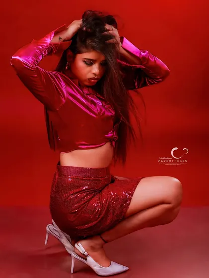 A crouching pose that adds an edgy, modern vibe. The focus is on the texture of the outfit and the subject's intense, downward gaze.