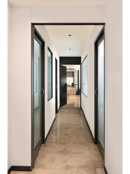 Corridors are more than just passages; they are opportunities for design. In Project Rooftop, I used clean lines, symmetry, and a strong contrast of black and white to create this sleek passageway. The glass doors maintain a sense of openness while defining separate spaces.