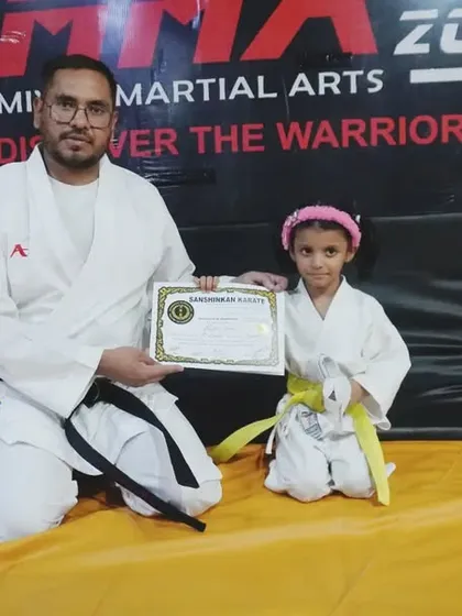 One of our youngest ninjas, proudly receiving her yellow belt. We start training kids from age 4, building a foundation of confidence and respect.