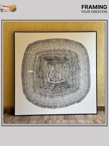 This large-scale charcoal drawing, an abstract of a tree's rings, required a minimalist yet strong frame. We chose a sleek black metal frame to provide structural support without distracting from the intricate line work of the piece.