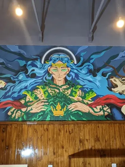A final look at the full "Mother Nature" mural, capturing its scale and presence within the two story cafe space.
