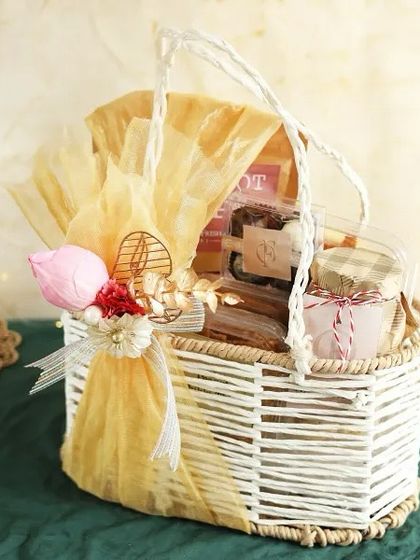 A charming white wicker basket filled with our handmade treats and wrapped in warm yellow tones. A cheerful and delightful gift for any celebration.