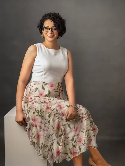 For this headshot, we chose a brighter, more casual look with a floral skirt. It shows that professional portraits can reflect your personal style while still looking polished and ready for business.