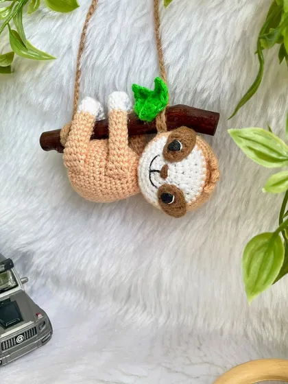 This adorable sloth car hanging was so much fun to make. He hangs lazily from a real wooden branch, adding a touch of cuteness to your car's rearview mirror.