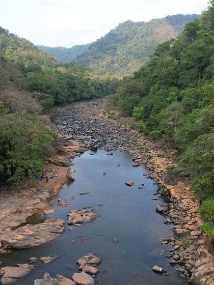 A drone shot of the Aghanashini river flowing through a rocky valley during the dry season.