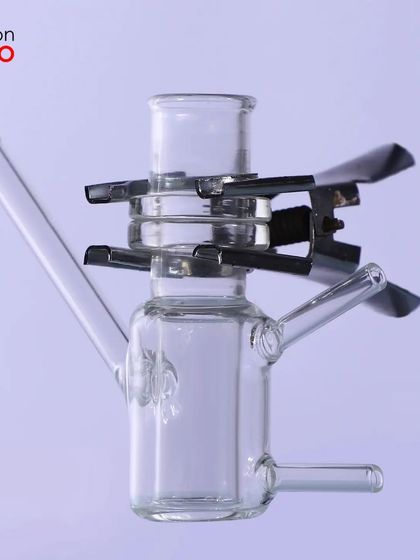 A glass instrument with a metal clip, showing how we can clearly photograph products made of multiple materials.