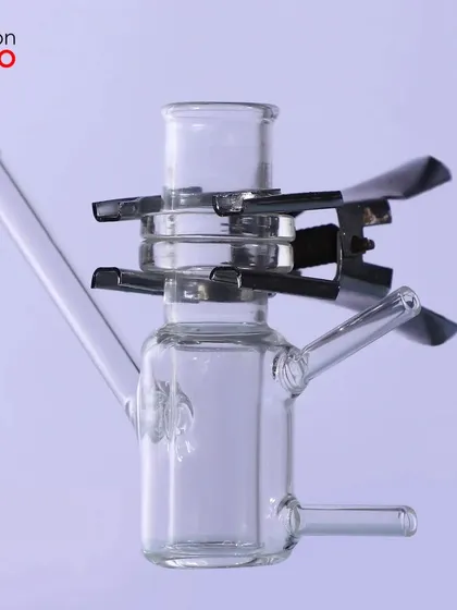 A glass instrument with a metal clip, showing how we can clearly photograph products made of multiple materials.