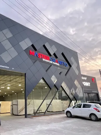 For this commercial facade for Master Granitto, we used angular forms and a sleek, dark ACP cladding to create a bold, modern identity. The design plays with geometry and reflection, making the building a landmark in its commercial environment.
