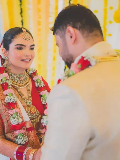 A beautiful moment between the bride and groom. Her makeup is soft and romantic, perfect for these intimate wedding moments.