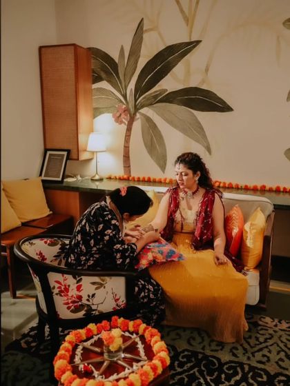 A behind-the-scenes shot of me applying mehendi for a bride in a beautiful, relaxed setting. I come to your location to make the experience as comfortable and special as possible.