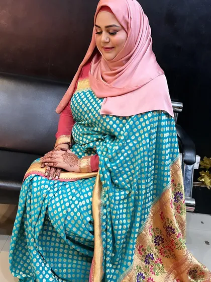 The same client, showing her full look. The combination of the pink hijab and the blue and gold saree is stunning.