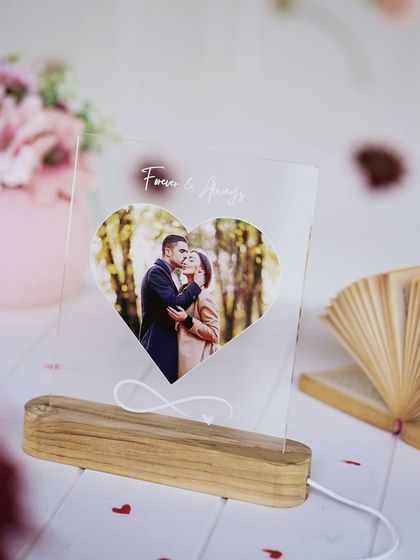 The heart-shaped LED lamp, unlit, showing the clear acrylic and the elegant engraving.