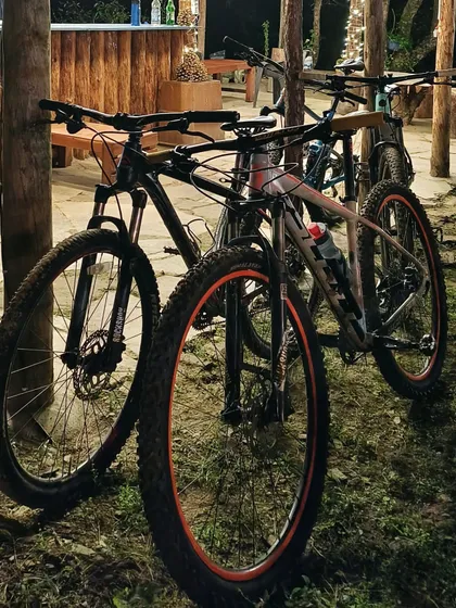A couple of hardtail mountain bikes parked after a day's ride. Cycling tours are the best way to truly experience a new place up close.