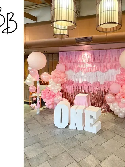 Another perspective of the 'ONE' birthday setup, showing how the balloon columns and fringe wall create a complete and immersive photo zone for the celebration.