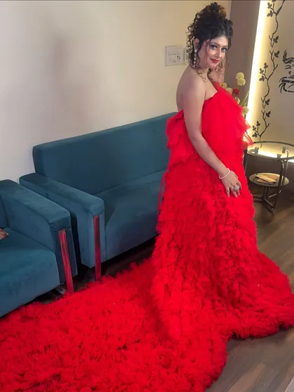 The full view of the red gown with its impressive trail. This is the kind of dress that makes everyone stop and stare.