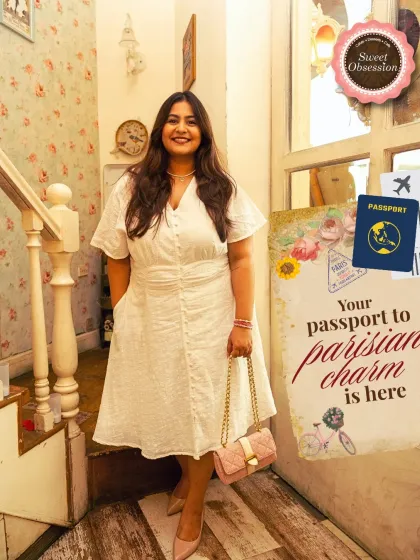 Your passport to Parisian charm is right here. A guest poses by our staircase, ready for her delightful escape to Paris, right here in Gurugram.