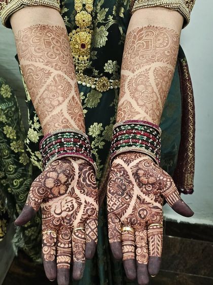 Both hands showcasing the lovely first-day stain. The design extends up to the elbows with a beautiful net pattern, and the color is already deep and even.