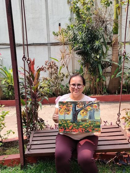 The perfect spot to admire your work. This student is sitting on a garden swing with the beautiful park bench painting she just completed.