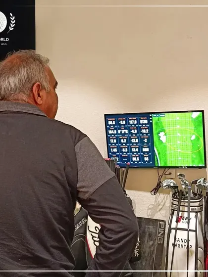 A client analyzing his shot data on the TrackMan screen. This visual feedback is a powerful tool for understanding your own swing mechanics.