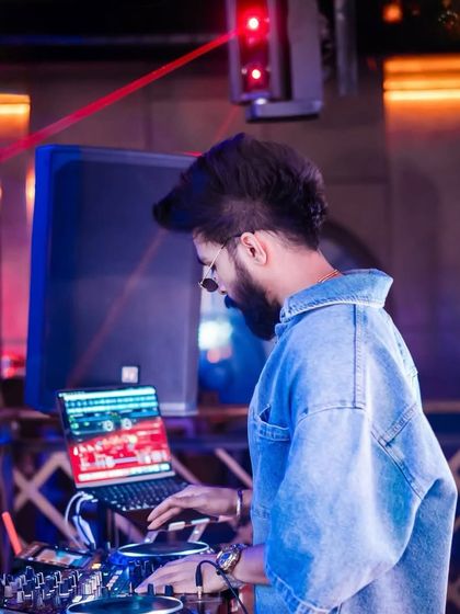 A side profile shot of me focused on my laptop and mixer. This is where I line up the next banger to keep the party going.