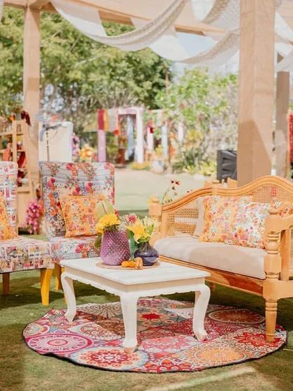 A fun, printed armchair and floor cushion add a pop of color and pattern to this lounge corner at the 'Rajasthani Folklore' Mehendi.