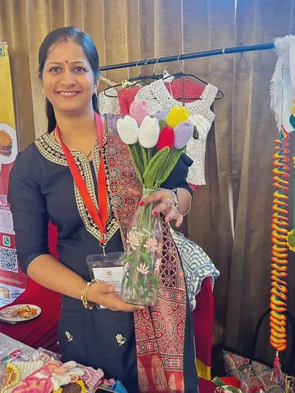 Holding a bouquet of my crochet tulips at my stall. I love meeting customers and sharing the stories behind my handmade pieces.