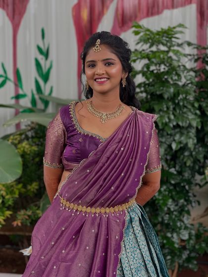 A full-length view of the purple and blue half-saree, a popular choice for pre-wedding events.