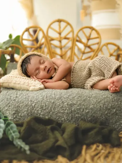 It's a boy! This little man looks so peaceful sleeping on this tiny bed. I love using natural props like this rattan bed for a gentle, organic feel.