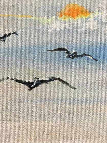 A minimalist seascape on a small canvas. Just a few brushstrokes are needed to suggest the sky, the sun, and birds in flight, creating a sense of vast, open space.