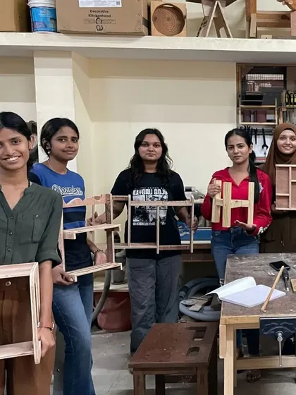 Another group of proud design students with their finished projects, which include a variety of unique and creative shelf designs.