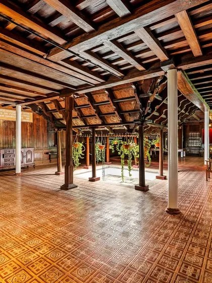 The central atrium of the Aranmula Palace, a classic feature of a 'Nalukettu' home. This open-to-sky courtyard brings light and nature into the heart of the building, enhancing its serene and positive energy.